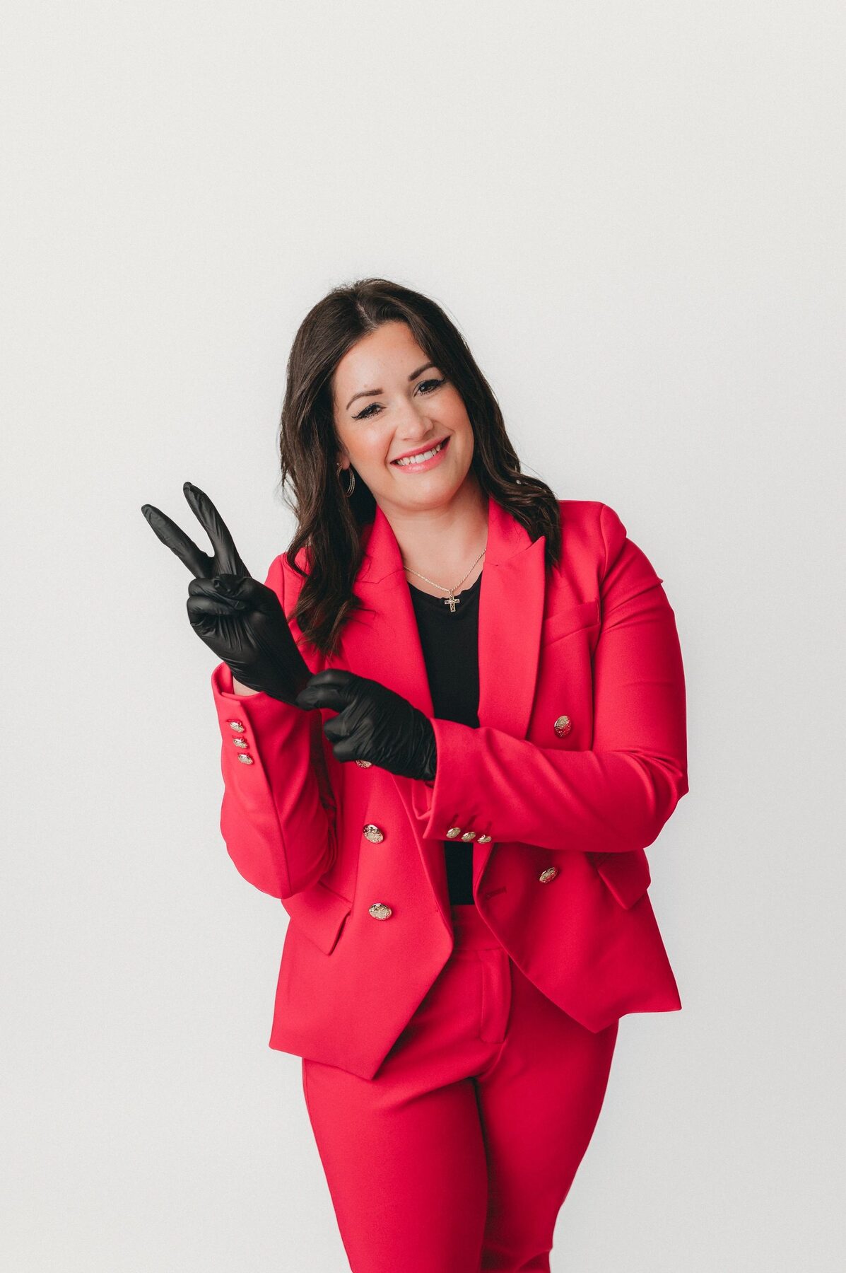 Rachel Rife in a red suit, smiling